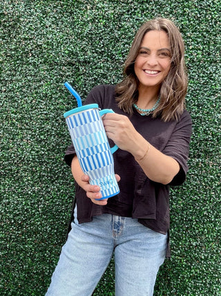 Girl holding a blue Swig cup