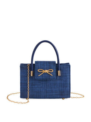 Blue handbag with a gold bow and chain detail on a white background