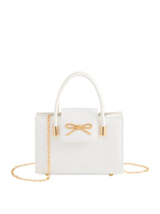 White handbag with a gold bow and chain detail on a white background