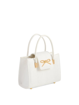 White handbag with a gold bow on a white background