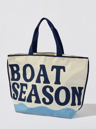 Beige tote bag with 'BOAT SEASON' text and blue wave design on a white background