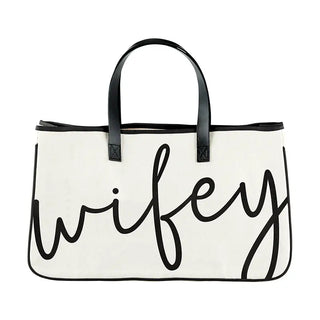 White tote bag with black handles and 'wifey' text on a white background