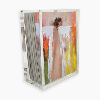 Abstract artwork with a person and colorful background in a clear acrylic frame.
