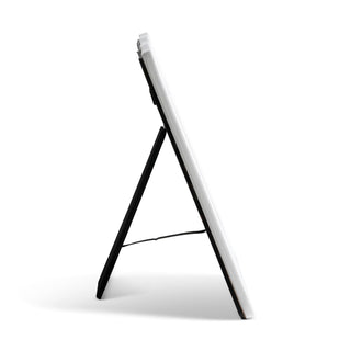 White electronic device on a black stand against a white background