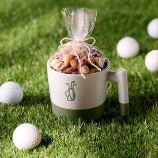 Golf-themed mug with a snack mix on grass surrounded by golf balls