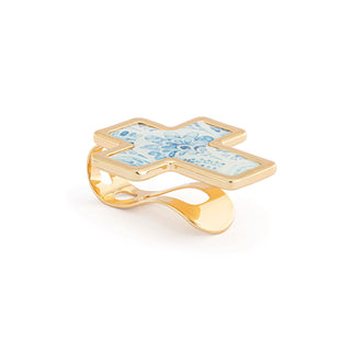 Gold cross-shaped ring with blue floral design on a white background