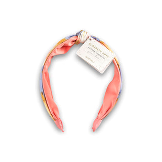 Colorful headband with a brand tag on a white background