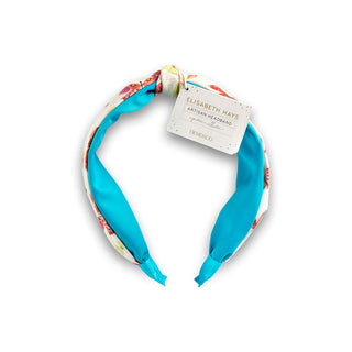 Colorful headband with a visible brand tag on a white background