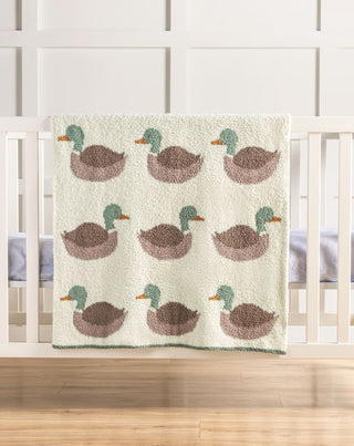 Blanket with duck pattern on a crib