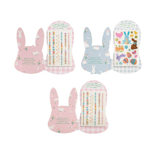 Set of four colorful oven mitts with bunny designs on a white background
