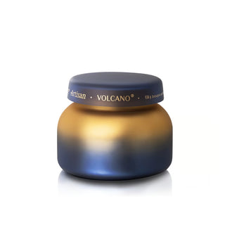 A small round cosmetic jar with a dark blue lid and a metallic gold-to-blue gradient body, shown on a plain white background.