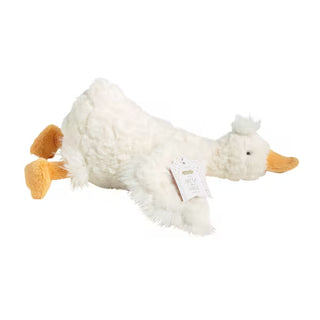 A plush white duck toy with orange feet and beak, lying on its side against a plain white background. A paper hangtag is attached to its side.