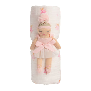 Stuffed doll in a pink outfit with a matching blanket on a white background