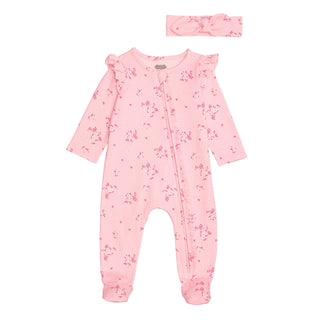 Pink baby onesie with floral pattern and matching headband on a white background