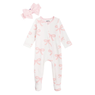 Baby onesie with pink bows and matching headband on a white background