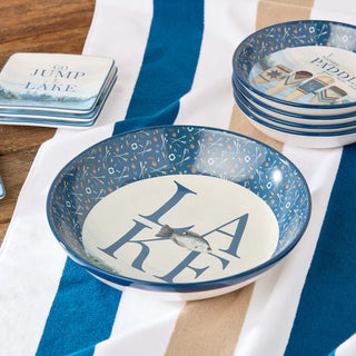 Decorative bowls with 'Lake' design on a striped cloth