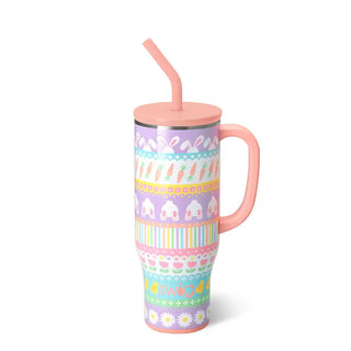 A pink handled travel tumbler with a matching pink lid and straw, decorated with pastel Easter-themed patterns including bunnies, carrots, and flowers on a white background.