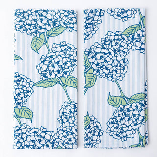 Two panels with blue and white floral design on a striped background
