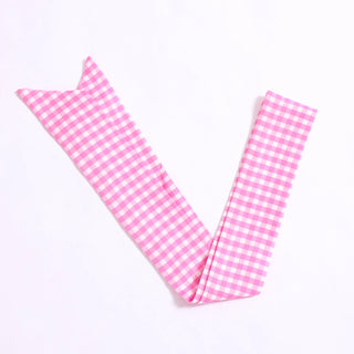 Pink gingham fabric on a white background