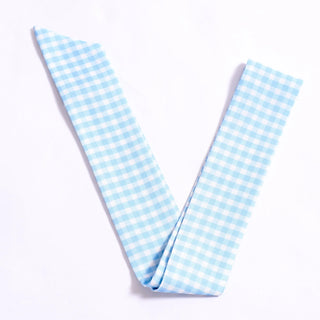 Light blue gingham checkered fabric on a white background