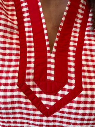 Red and white striped garment with a deep V-neck