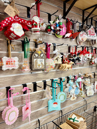 Display of various decorative items on a wooden wall with a shopping cart below.