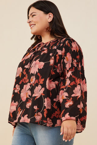 Woman wearing a floral blouse with a beige background