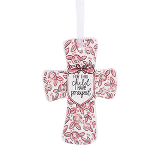 Decorative cross with floral patterns and text on a white background