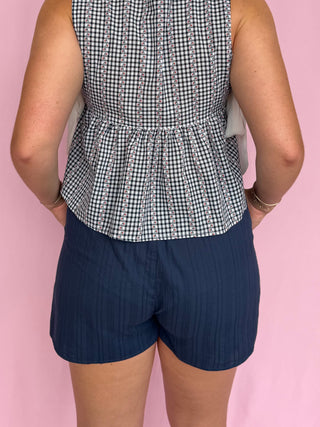 woman wearing navy shorts