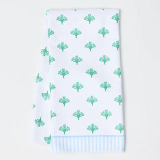 White towel with green leaf pattern on a white background