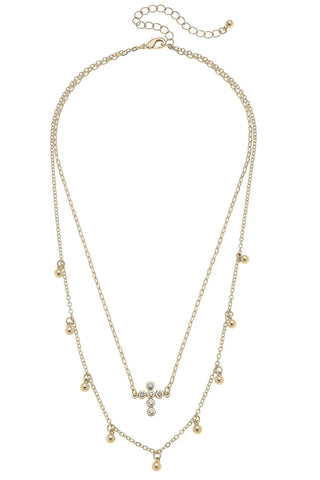 Gold necklace with a cross pendant on a white background