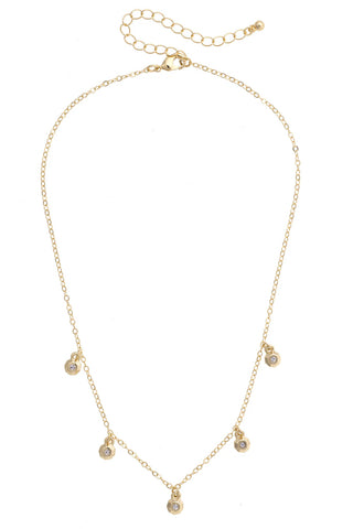 Gold necklace with small round pendants on a white background