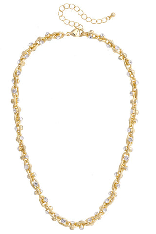Gold chain necklace with small pearls on a white background