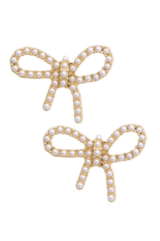 Gold bow-shaped earrings with pearl details on a white background