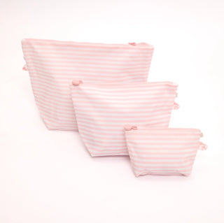 Three pink and white striped zippered pouches in different sizes arranged on a white background.