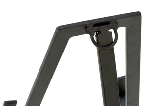 Close-up of a black metal chair frame on a white background