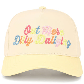 Yellow cap with colorful text 'Out Here Dilly Dallying' on a white background