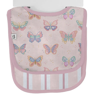 A baby bib with a pastel pink background and multicolored butterfly print, featuring a pink border and white vertical stripes on the lower front.