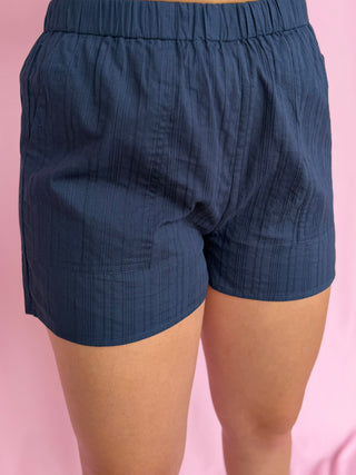 woman wearing navy shorts