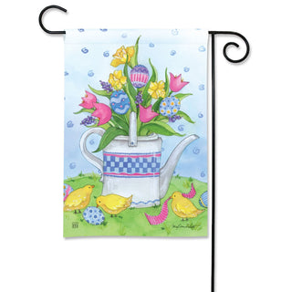 Decorative garden flag with a teapot and flowers design, featuring birds and a blue sky.