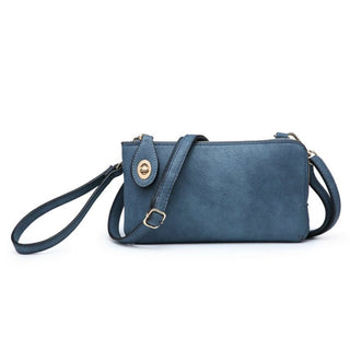 A blue faux-leather crossbody clutch bag with a wristlet strap, gold-tone hardware, and a zip-around closure, shown against a plain white background.