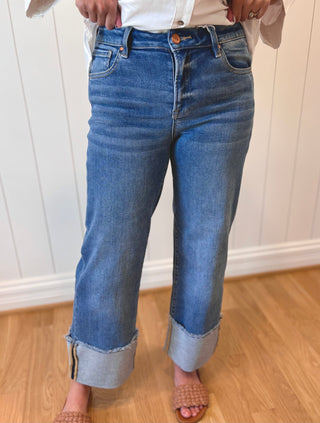 Person wearing blue jeans with a white background
