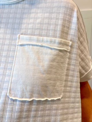 Plaid shirt with a pocket on a neutral background