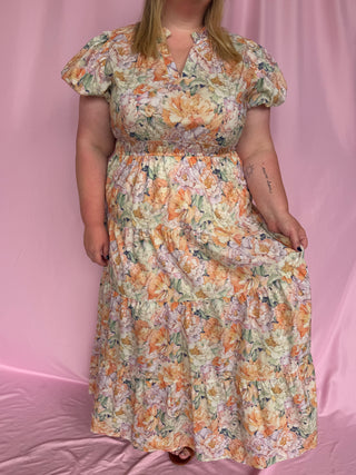 Woman wearing a floral dress against a pink background