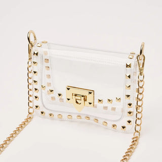 Clear handbag with gold chain and studded details on a white background