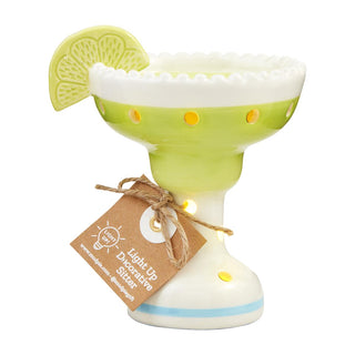 Decorative margarita glass with a lemon wedge on a white background