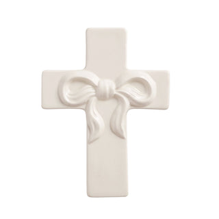 White cross with a bow design on a white background