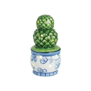 Decorative ceramic piece with green textured spheres on a white background