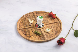 Wooden round tray with engraved designs on a light background