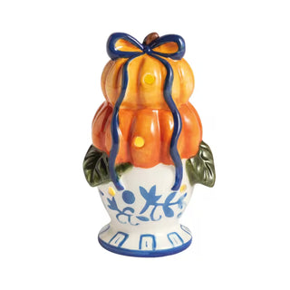 Ceramic pumpkin-shaped vase with a blue bow on a white background